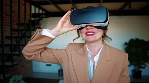 Woman smiling while using a Virtual Reality headset in an office