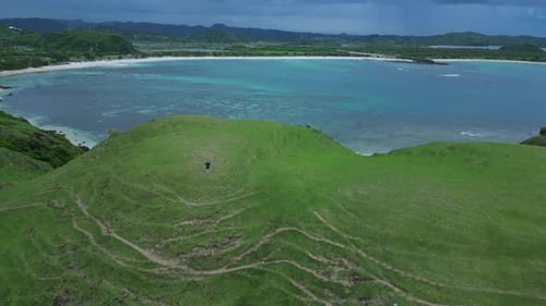 Solitary Figure Atop Hill Surveys Broad Oceanic Horizon And Distant Coastlines