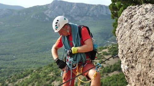 Climber Snaps the Safety Carabiner on the Rope