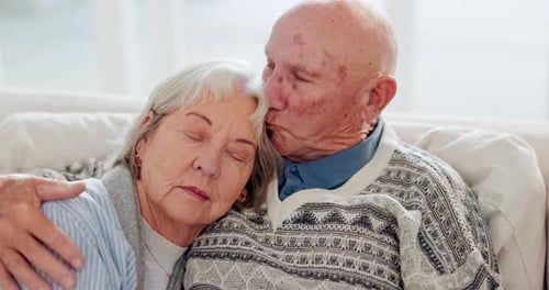 Affectionate Senior Couple Embracing on Couch