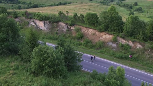 Scenic Aerial View of Countryside Road with Walkers