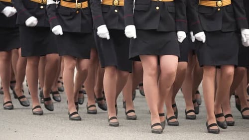 Women in Military Uniforms Marching in Formation