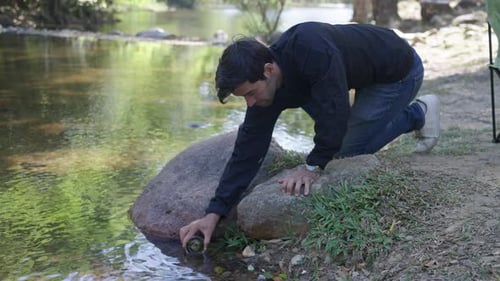 The environmentalist is testing a water Stream in the forest.