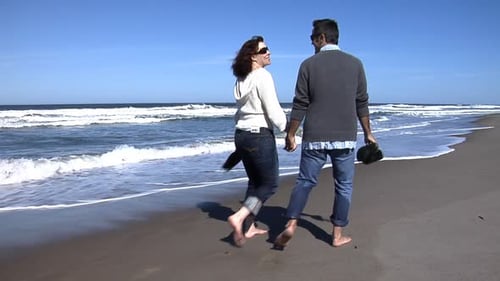 Couple Walking on the Beach Barefoot