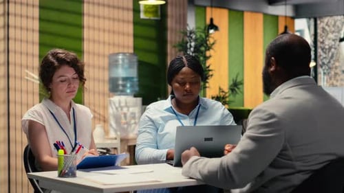 Diverse Recruiters Evaluating an Applicant CV Resume During Interview Session