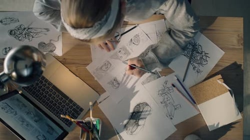Young Woman Works on a Storyboard in a Design Studio Draws Sketch for the Videos