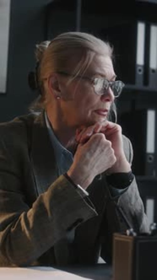 Worried Woman Sits at Her Office Desk