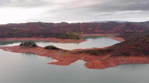 Cloudy sky and low water levels on a reservoir due to extreme drought