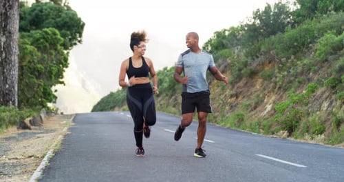 4k video footage of an athletic young couple running together outdoors