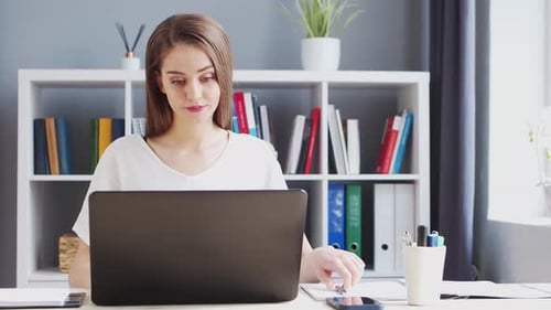 Young Woman Works at Home Office Using Computer Workplace of Female Entrepreneur Freelancer or