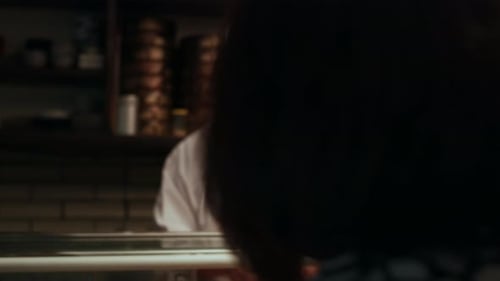 Japanese Couple Sitting At A Sushi Bar Watching The Expert Chef Slice Fish In Small Sushi Bar Wit...