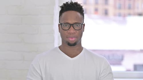 Man Smiles with Glasses Close Up Indoors