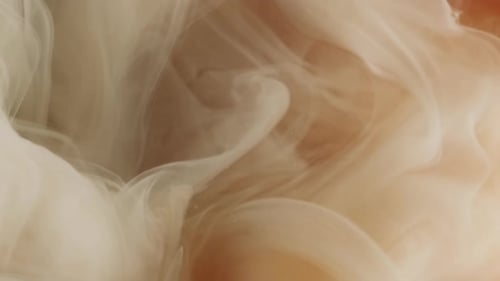 Creamy White Liquid Flowing into Amber Fluid