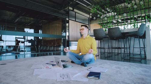 In a Modern Office a Dedicated Young Professional Uses Mindfulness Techniques Highlighting the