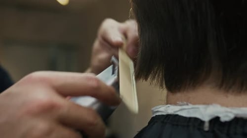 Barber Trimming Hair with Electric Trimmer Close Up