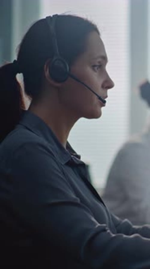 Focused Woman Working with Headset in Office