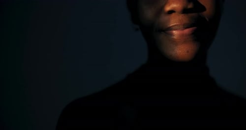Woman Smiling Intensely in Dark Close Up
