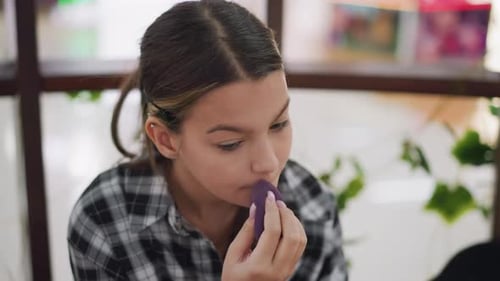 Young Woman Applying Makeup with a Sponge