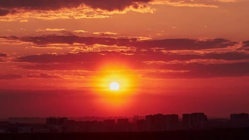 As the sun dips below the horizon, the sky transforms into a canvas of vibrant colors. The city skyl