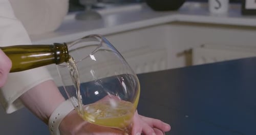 Pouring Pale Beer Into a Tall Glass