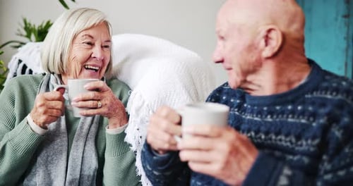 Elderly Couple Enjoying Hot Drink Together at Home