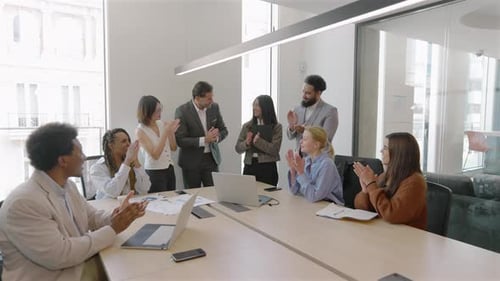 Diverse Team Celebrates Success in Modern Office