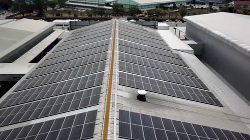 Aerial Drone View of Solar Panels Installed on a Factory Roof