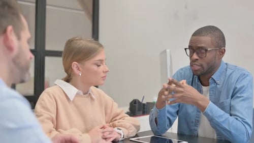 Close up of African Man Talking with Colleagues