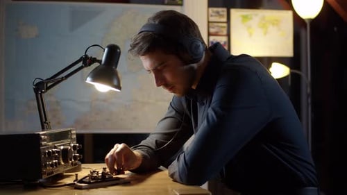 Young Man Operating Vintage Morse Code Radio