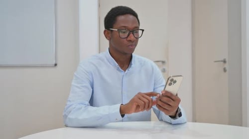 Young Adult Using Mobile Phone Indoors