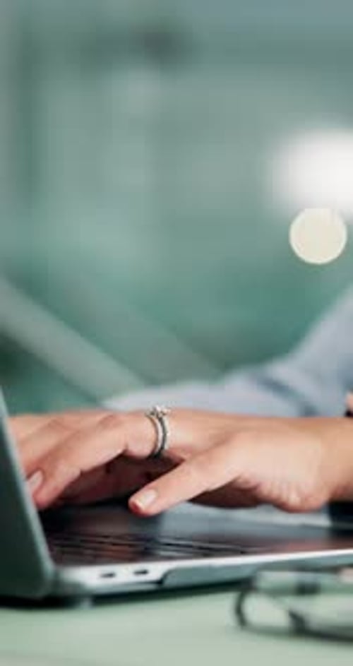 Woman Typing on a Laptop Keyboard Close Up