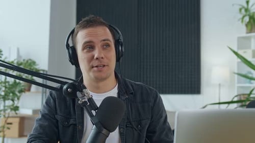 Young Adult Recording Podcast with Microphone and Laptop