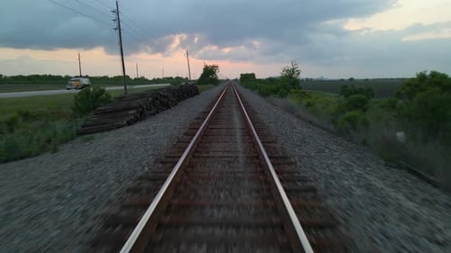 Drone Shot Flying Quickly Over Empty Railroad Track Before Lifting Up And Out Over Empty Field In Te