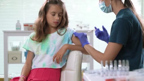 Doctor Giving Vaccine to a Child in Clinic