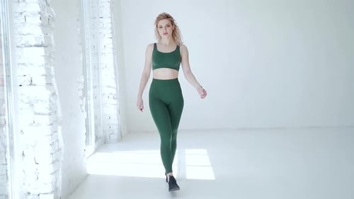 Blonde Woman Poses in Green Athletic Wear