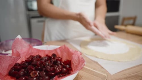 Woman Baking Cherry Pie in Sunny Kitchen