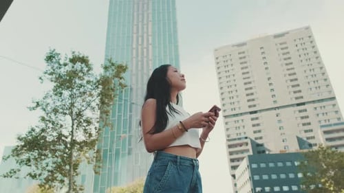 Woman Using Cellphone in Urban Setting