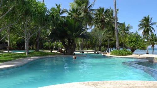 A Couple Of Tourist Swim On The Swimming Pool On A Hot Summer Day In Dos Palmas Island Resort And Sp