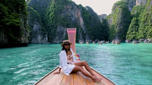 Women in Front of Longtail Boat at the Lagoon of Koh Phi Phi Thailand