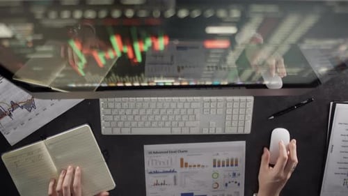 Closeup of a Workplace with a Computer and Documents with Graphs in the Office