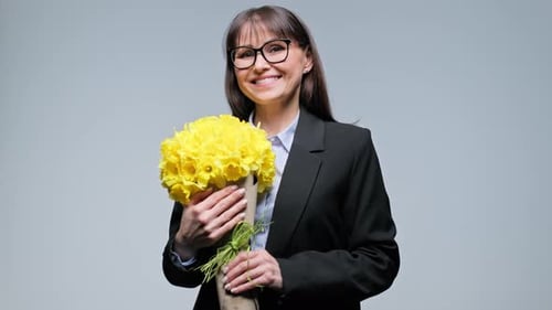 Smiling Woman Holding Yellow Flowers