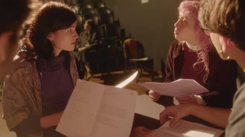 Drama Students Reading Play Scripts on Theater Stage