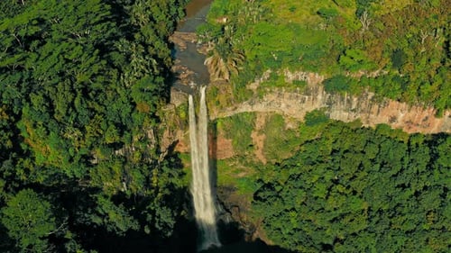 Flying over with Top Down Camera of the Chamarel Waterfall at the Mauritius Island during Sunset.