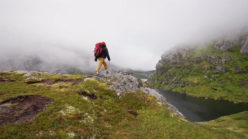 Back View of a Traveler Woman Climbed to the Top of the Mountain and Raised Her and Hands Up