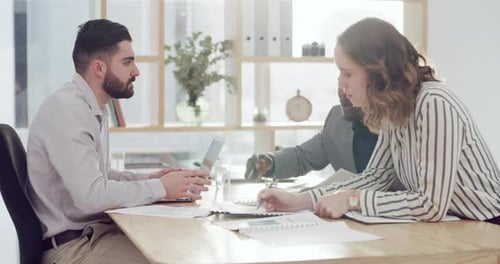 4k video footage of a group of businesspeople going through paperwork together in an office