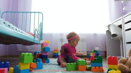 Baby Plays with Toys in Bright Room
