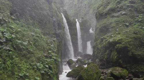 Drone move in close shot of Waterfall in the jungle Costa Rica