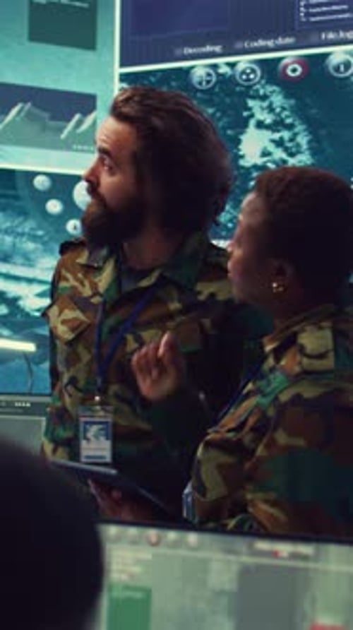 Military Personnel Analyze Data on a Tablet Computer