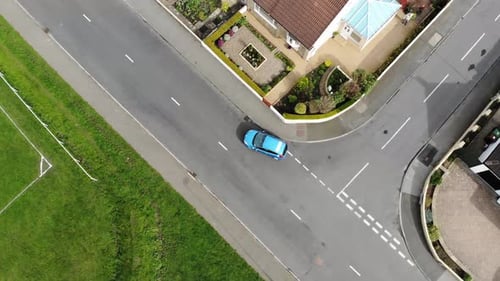 Aerial drone footage of a driving instructor teaching a student how to do a reverse around a corner