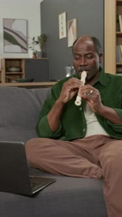 Vertical Shot of Mature African American Man Following Online Lesson